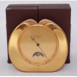 A contemporary Swiss made quartz brass mantel clock by 'Jean Roulet Le Locle' the plain gilt dial