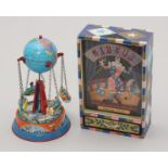 A clockwork musical dancing circus clown, together with a tin-plate rotating globe fairground ride.