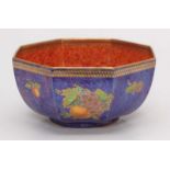 A Wedgwood octagonal lustre bowl decorated with an orange interior and the blue exterior with images