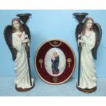 An oval porcelain plaque hand-painted with the Madonna and Child, mounted on an oval wall plaque,