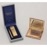 A Christian Dior gilt metal compact and a gilt metal cigarette lighter, in original box with