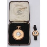 An early 20th century 9ct gold half-hunter wristwatch with cloth strap, together with a gold-