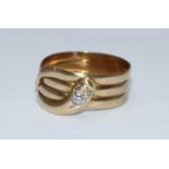 An 18ct gold coiled serpent ring set with three old cut diamonds, 8.11g, estimated total diamond