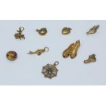 Eight 9ct gold bracelet charms including ballet slippers, kettle, genie lamp, basket of fruit, fish,