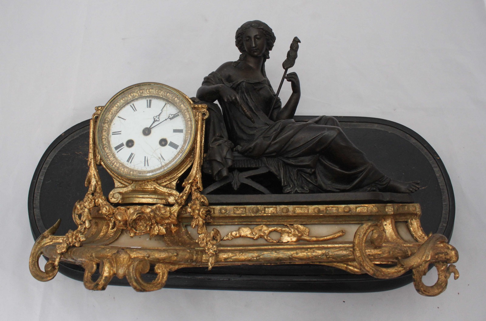 A 19th century French gilt spelter mantel clock, Japy Fils movement, a reclining lady in Grecian