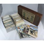 Two boxes of assorted postcards including local scenes, together with a wooden box containing