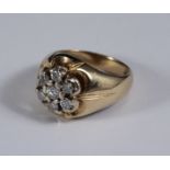 A 14ct gold diamond cluster ring, with scalloped mount and wide shoulders, claw-set with seven round