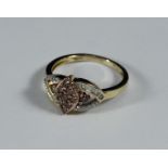 An 9ct gold ring set with a central marquise cluster with a diamond to each side, all round