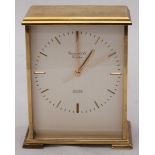 A gilt-metal quartz mantel clock by Garrard & Co. London, the silvered dial with batons denoting