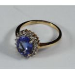 ADDENDUM - Ring is Tanzanite not Sapphire. An 18ct gold cluster ring claw-set with a central oval