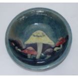 A Moorcroft pottery large bowl in the 'Claremont' pattern, painted with toadstools to a blue ground,