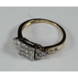 A 9ct gold ring tension-set with nine princess-cut diamonds to the square top, claw set with three