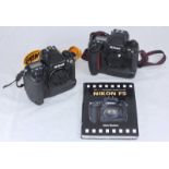 Two Nikon F5 Professional 35mm Film SLR Cameras - Bodies Only, with neck straps, both switch on