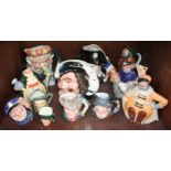 SECTION 34. A collection of 11 various Royal Doulton character jugs and teapots, including '