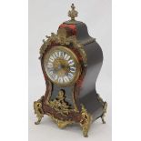 A 19th century French Boulle work mantel clock, of waisted balloon form with floral pediment,