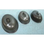 Three metal graduated oval dome meat covers