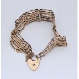 A 9ct gold gate-link bracelet with heart-shaped locking clasp. Gross weight approximately 11.6g.