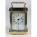 A brass carriage clock, the top with exposed platform escapement, the white enamel dial with Roman