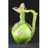 A 19th century green glazed Turkish 'Canakkale' jug, with applied gilt moulded decoration. 33cm