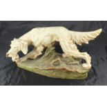 A Royal Dux porcelain model of a setter carrying a pheasant, impressed number 876, triangular pad