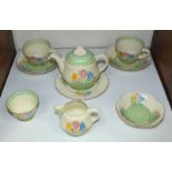 SECTION 27. A Clarice Cliff 'Spring Crocus' pattern part tea set comprising small teapot, two tea