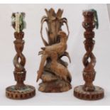 An antique carved limewood sculptural candlestick modelled as birds amidst foliage, 44cm high,