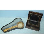 A walnut and brass bound writing box, with central brass engraved monogram, the cover lifting to