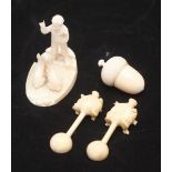 An ivory figure of a man with a sack of food facing two expectant rabbits, (one foot missing),