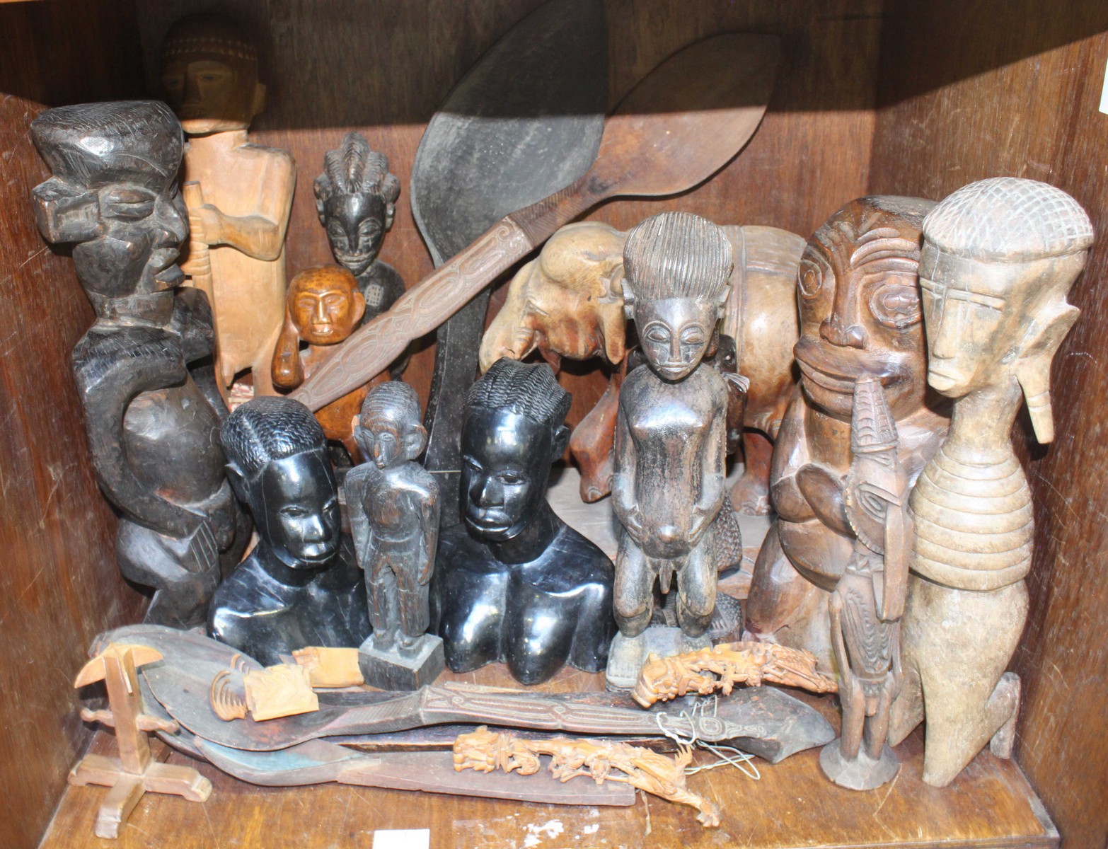 a collection of African and Asian carved wooden figures