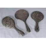 Three assorted silver-backed hand-mirrors, one by Asprey of London.