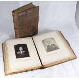 A Victorian brown leather-bound photo album with gilt-edged pages, complete with photos and