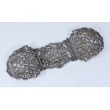 A Victorian silver three-piece Nurse's buckle, with pierced and scrolled decoration depicting