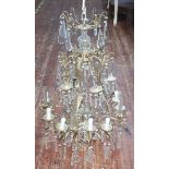 A brass three-tier, nine-light chandelier with glass drops, 90cm high. (AF)