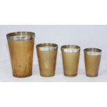 A set of four graduated horn hunting beakers, each with silver mounted rims by Louis Dee, hallmarked