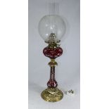 A late 19th / early 20th century ruby-cased and cut glass oil lamp, converted to electricity, with