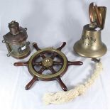 A small brass-mounted stained wood ship's wheel, together with a copper anchor light and brass