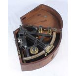 An early 20th century lacquered metal and brass sextant with various fitted brass lens and