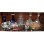 Three assorted glass decanters and stoppers, together with a glass ship in a bottle and another
