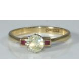 An 18ct gold ring eight claw set with a solitaire diamond and a rubover set with a small ruby to