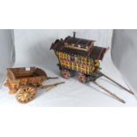 A hand-made painted wooden model of a gypsy caravan approx. 30cm high, together with a wooden