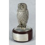A finely cast and chased silver model of an owl mounted on turned wooden socle with un-engraved
