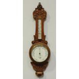 An early 20th century aneroid barometer by Dolland, London, No.6279, in carved oak case, 87cm