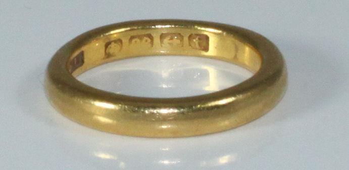 A 22ct gold plain wedding band, 7.29grams, size-M