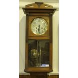 A 1920's style walnut cased wall clock by Gustav Becker, silvered dial with Arabic numerals,