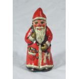 An Arnold lithographed tinplate clockwork Santa, approx. 10cm high