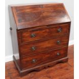 A George III mahogany bureau, the fall front enclosing a fitted interior with pigeonholes and