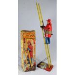 A mid-20th Century 'Climbing Fireman' by Marx of Great Britain, with plastic clockwork fireman,