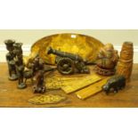 A collection of assorted treen items and wooden sculptures including a cannon and a baby lying on