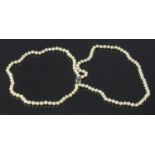 A two row necklace of uniform cultured pearls, measuring 5.7mm, with 18ct gold sapphire and