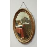 A gilt framed oval mirror, 90 x 65cm including frame